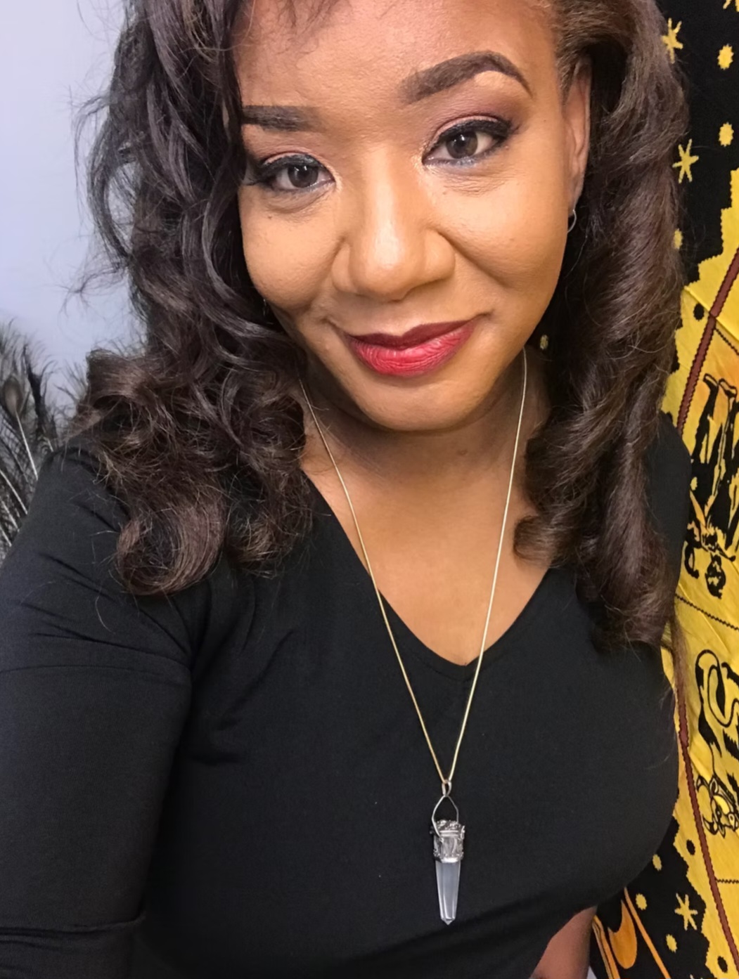 Close-up portrait of Ericka Boussarhane with a quartz pendulum necklace
